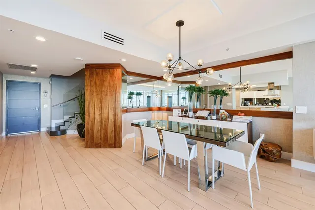 a living room with furniture a flat screen tv and kitchen view