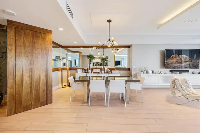a very nice looking living room with a large window and wooden floor