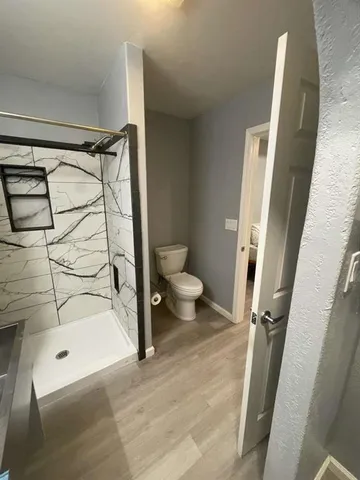 a bathroom with a sink toilet and shower