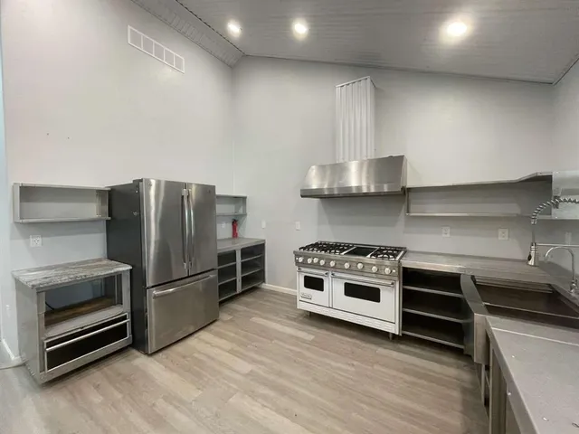 a kitchen with stainless steel appliances granite countertop a stove and a refrigerator