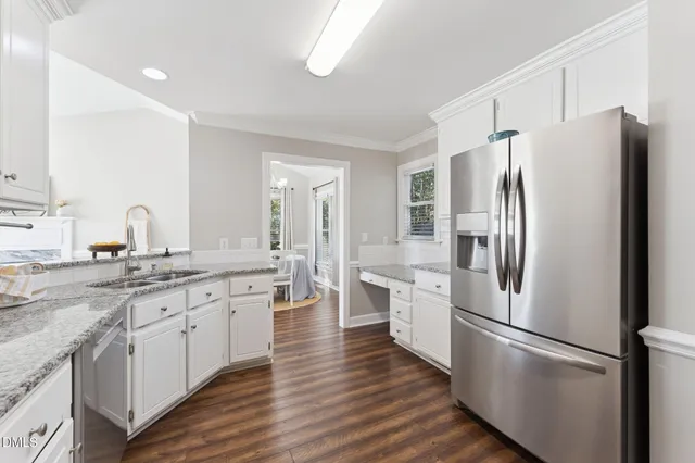 a kitchen with stainless steel appliances a refrigerator sink and microwave