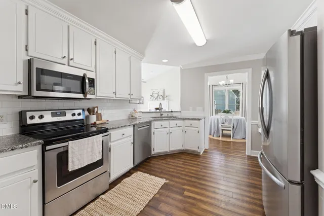 a kitchen with a sink stove and refrigerator