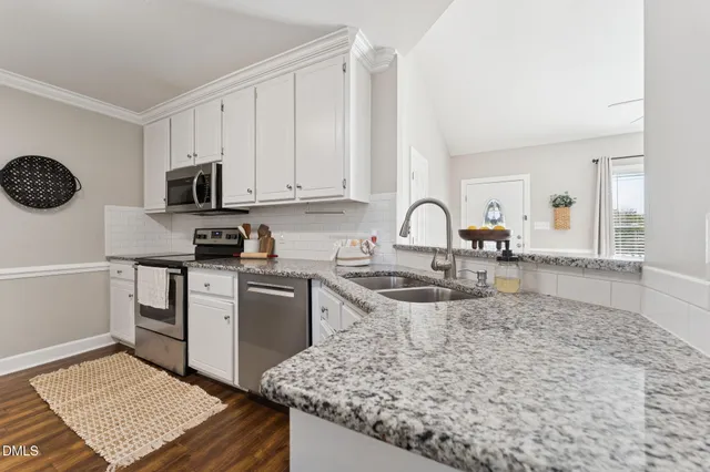a kitchen with a sink stove and cabinets