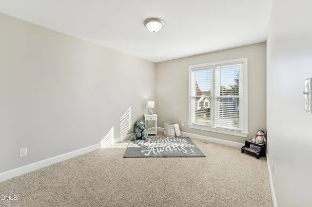 a spacious bedroom with a bed and a window