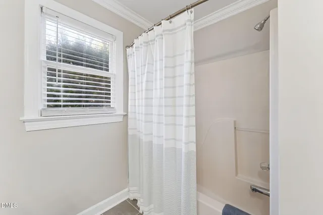 a bathroom with a shower and a window
