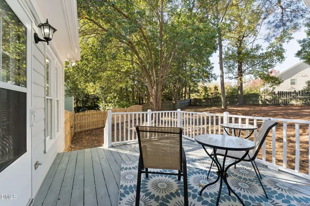 a view of balcony with furniture and wooden fence