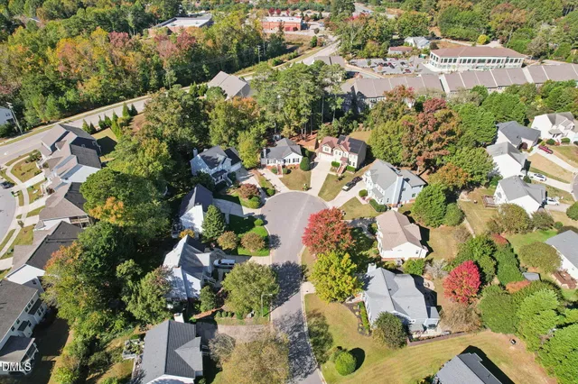 an aerial view of a house with a yard and fountain