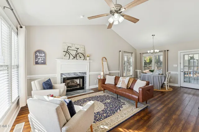 a living room with furniture fireplace and wooden floor