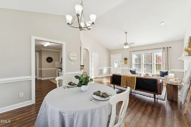 a view of a dining room with furniture wooden floor and chandelier