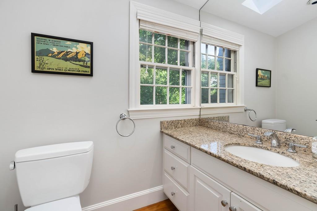 23 Glen Road Wellesley, MA 02481 - Photo 12 of 30 a bathroom with a granite countertop toilet a sink and a window