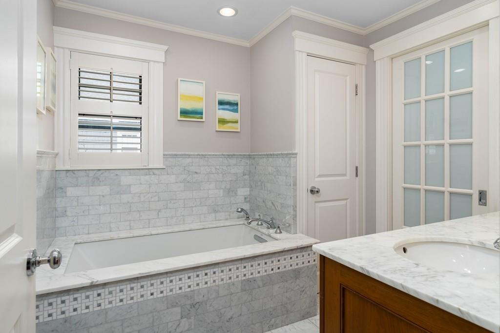 23 Glen Road Wellesley, MA 02481 - Photo 17 of 30 a bathroom with a tub a sink and a window