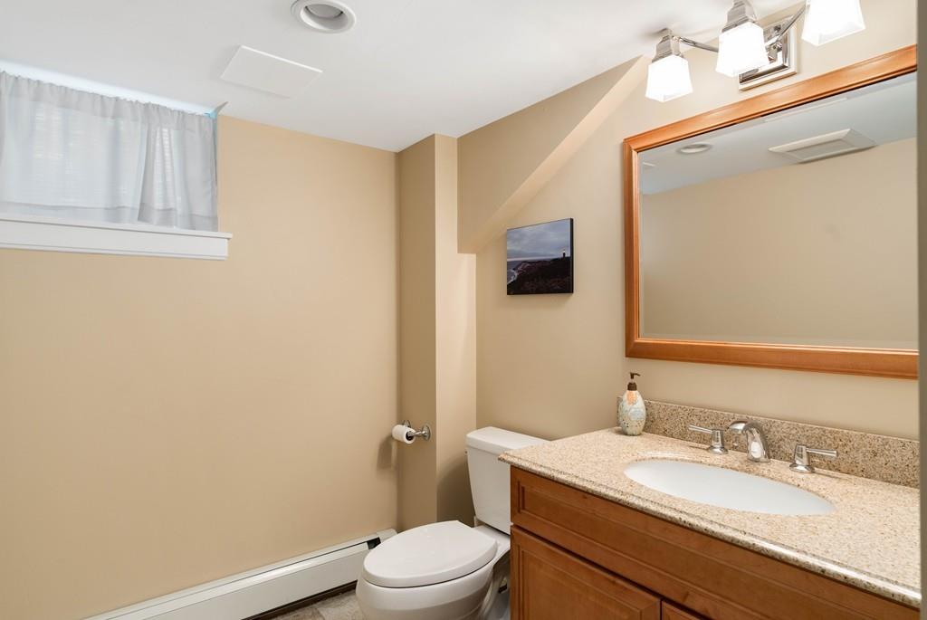 23 Glen Road Wellesley, MA 02481 - Photo 21 of 30 a bathroom with a granite countertop sink mirror vanity and toilet