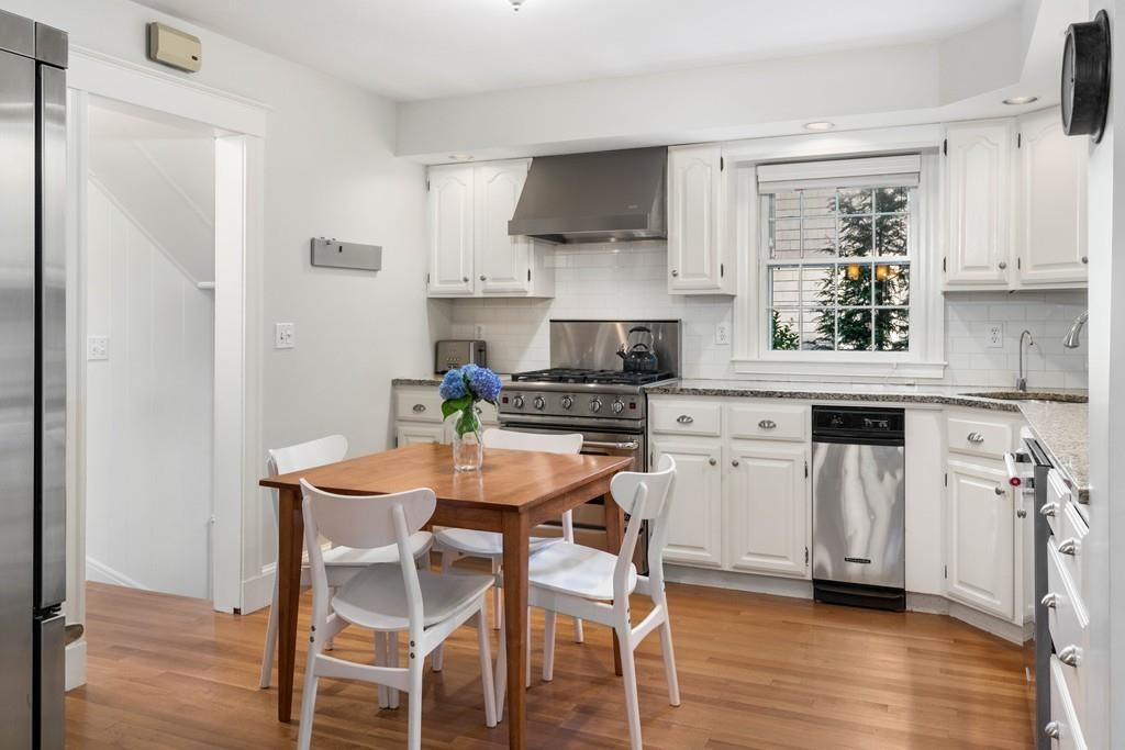 23 Glen Road Wellesley, MA 02481 - Photo 8 of 30 a kitchen with stainless steel appliances white cabinets and wooden floor