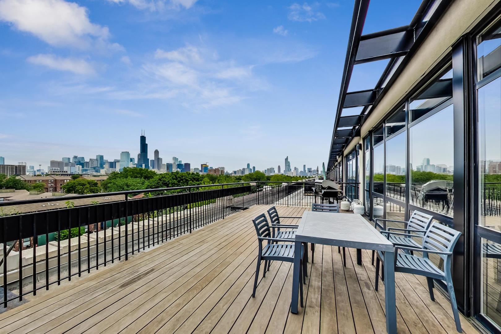 1069 West 14th Place, Unit 310 Chicago, IL 60608 - Photo 22 of 25 a view of balcony with outdoor seating and city view