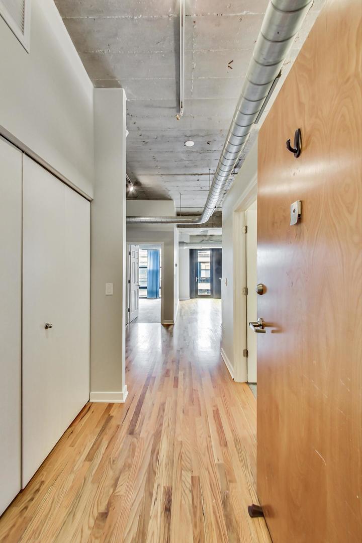 1069 West 14th Place, Unit 310 Chicago, IL 60608 - Photo 3 of 25 a view of hallway with wooden floor