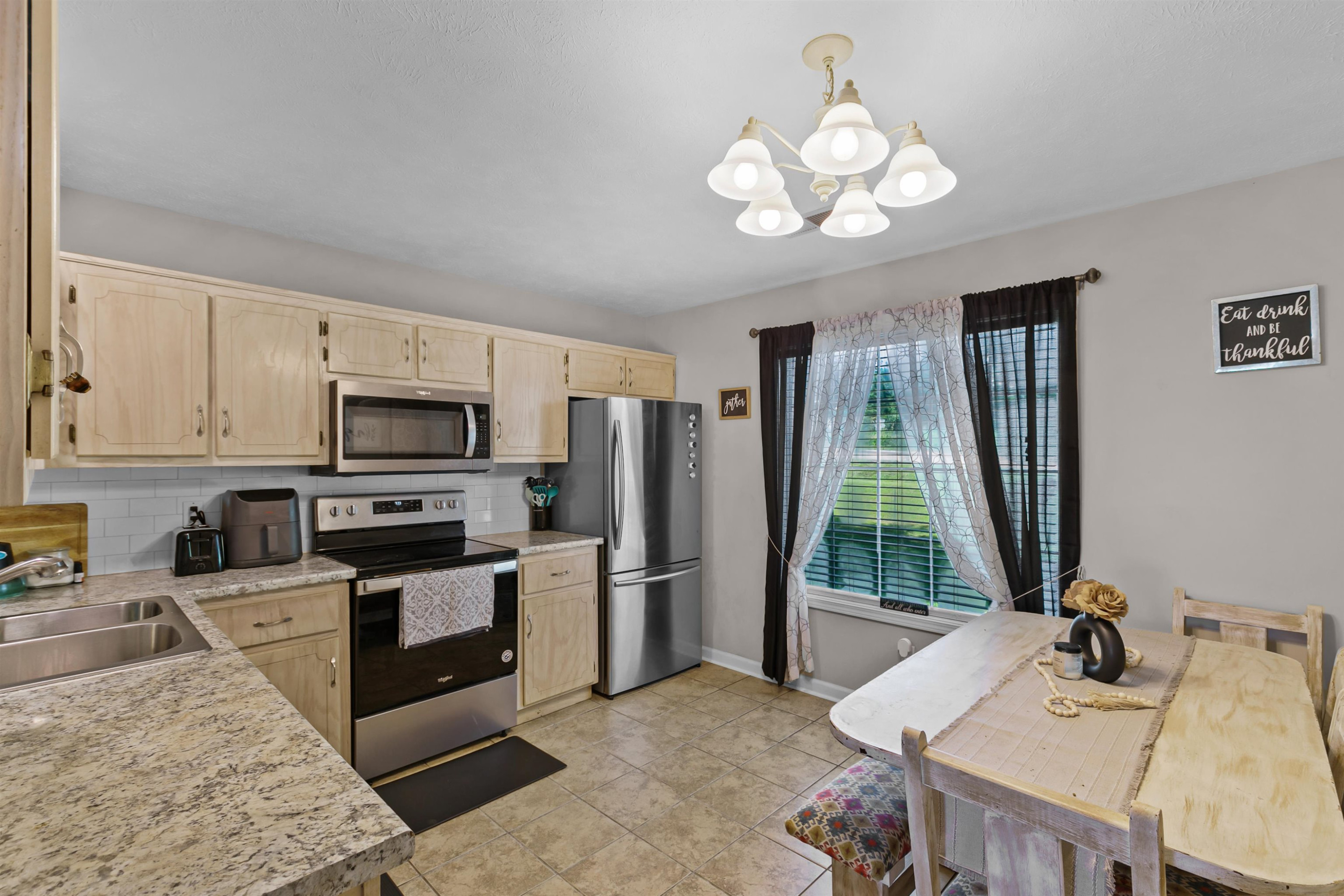 686 Gobelet Road Medon, TN 38356 - Photo 7 of 14 a kitchen with stainless steel appliances granite countertop a sink refrigerator stove and microwave
