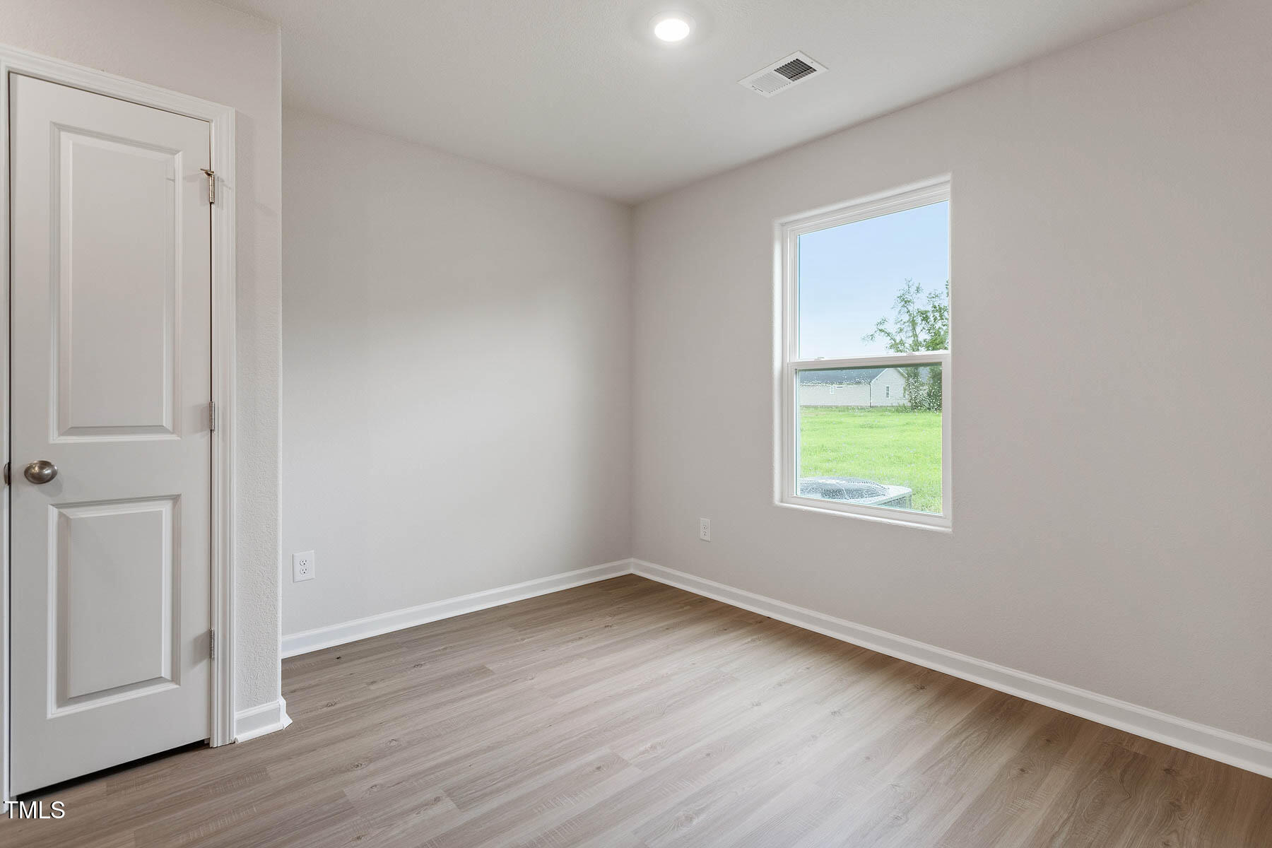 9080 Ava Drive Bailey, NC 27807 - Photo 11 of 20 an empty room with wooden floor and windows