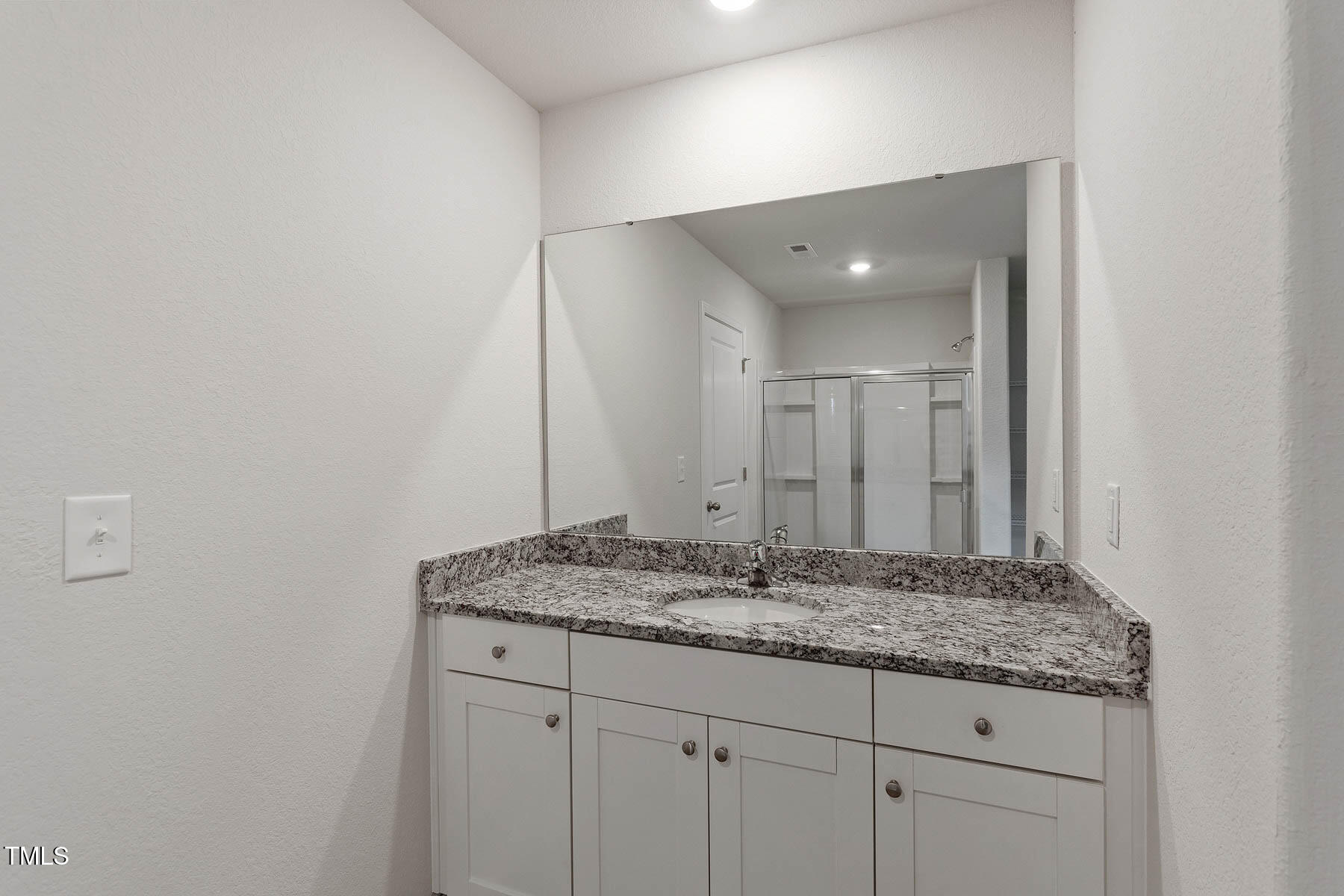 9080 Ava Drive Bailey, NC 27807 - Photo 14 of 20 a bathroom with a granite countertop sink and a mirror