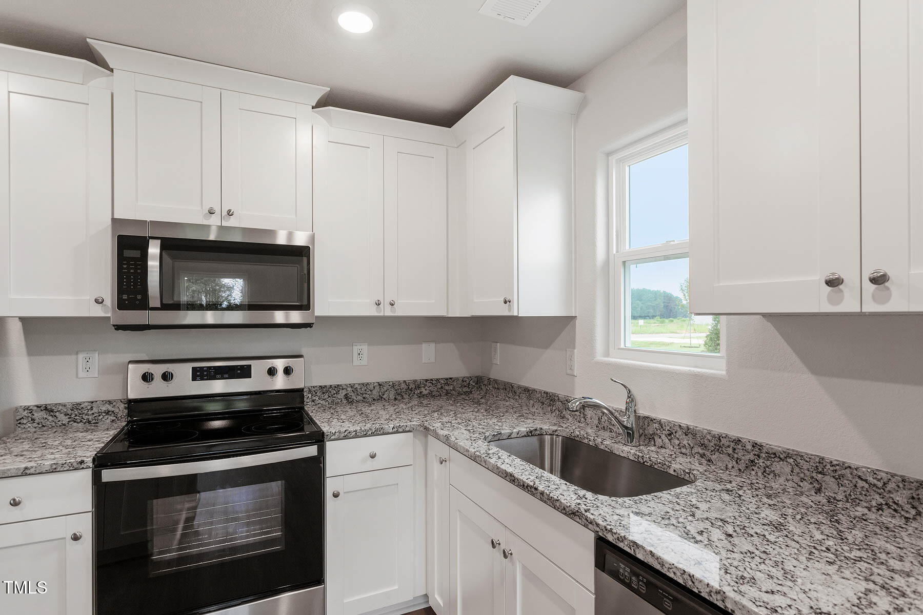 9080 Ava Drive Bailey, NC 27807 - Photo 9 of 20 a kitchen with granite countertop white cabinets and a stove