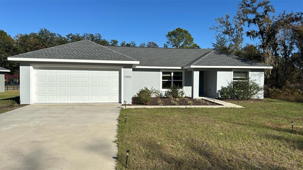 15945 Southwest 57th Terrace Road Ocala, FL 34473 - Photo 1 of 24 front view of a house with a yard