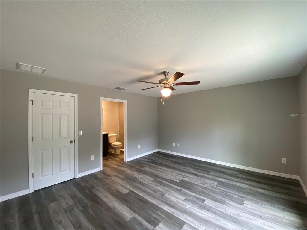 15945 Southwest 57th Terrace Road Ocala, FL 34473 - Photo 14 of 24 wooden floor in an empty room
