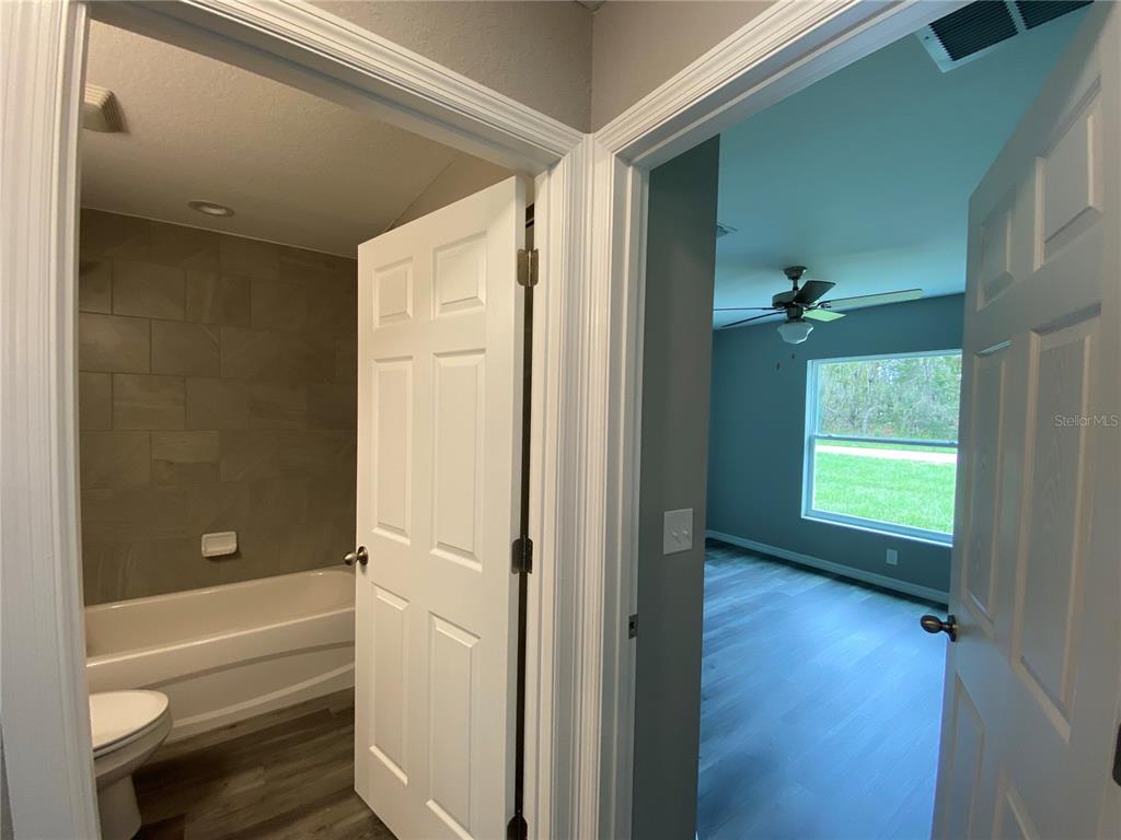 15945 Southwest 57th Terrace Road Ocala, FL 34473 - Photo 16 of 24 a bathroom with a tub and a shower