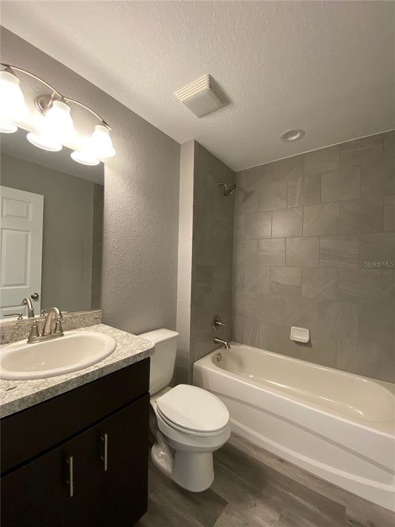 15945 Southwest 57th Terrace Road Ocala, FL 34473 - Photo 19 of 24 a bathroom with a bathtub a sink a toilet and a mirror