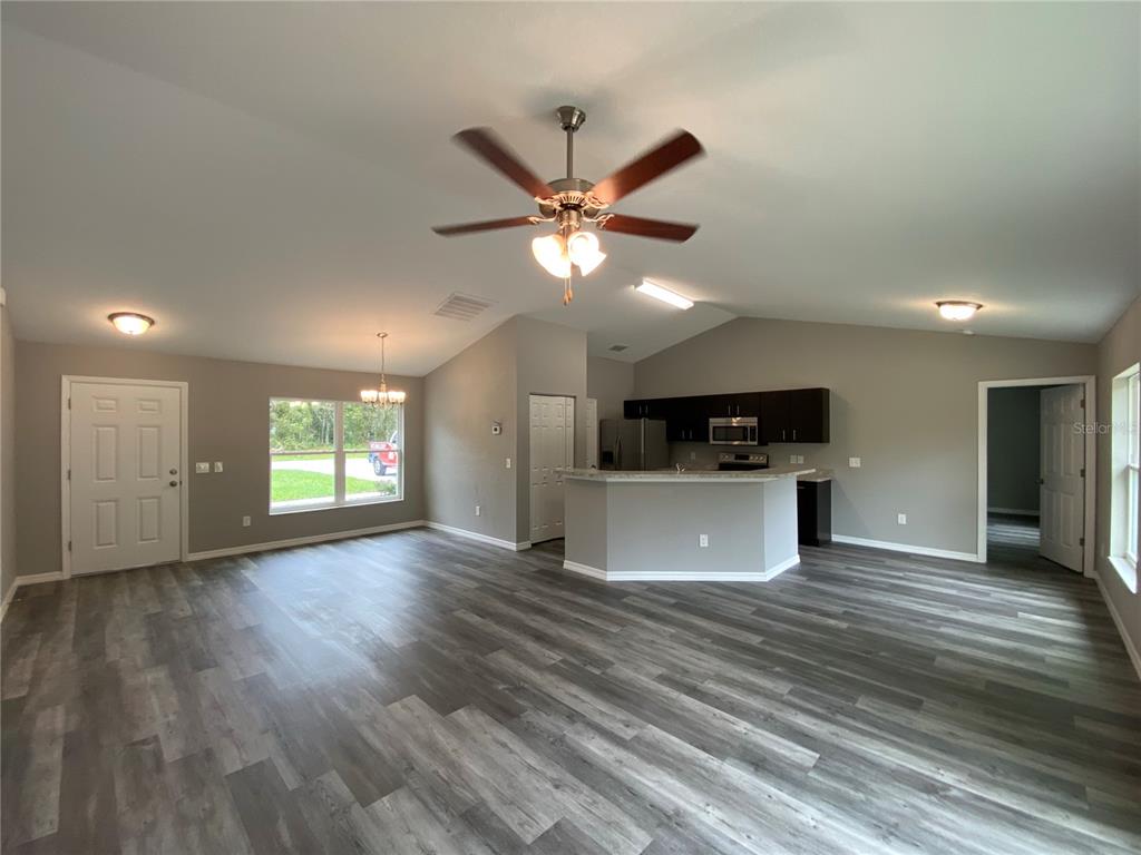 15945 Southwest 57th Terrace Road Ocala, FL 34473 - Photo 7 of 24 a view of an empty room with window and wooden floor