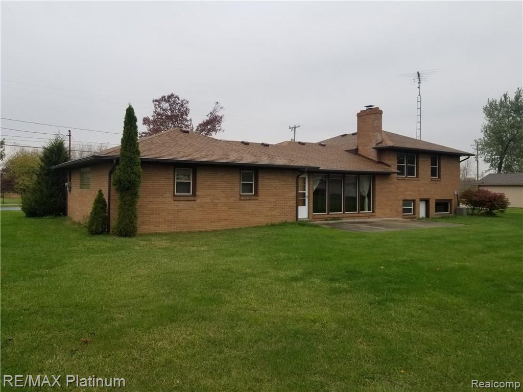 Rear of home all brick, hip roof, walk out lower level.