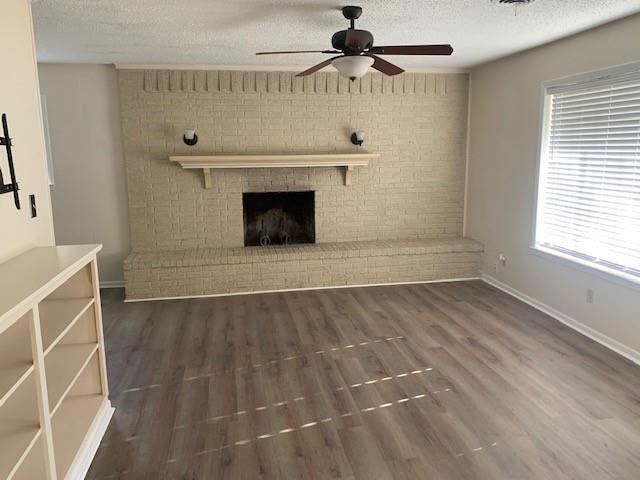 3104 South Lipsey Street Decatur, TX 76234 - Photo 4 of 18 a view of a livingroom with a fireplace a ceiling fan and window