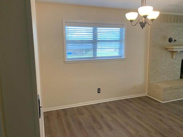 3104 South Lipsey Street Decatur, TX 76234 - Photo 6 of 18 wooden floor in an empty room with a window