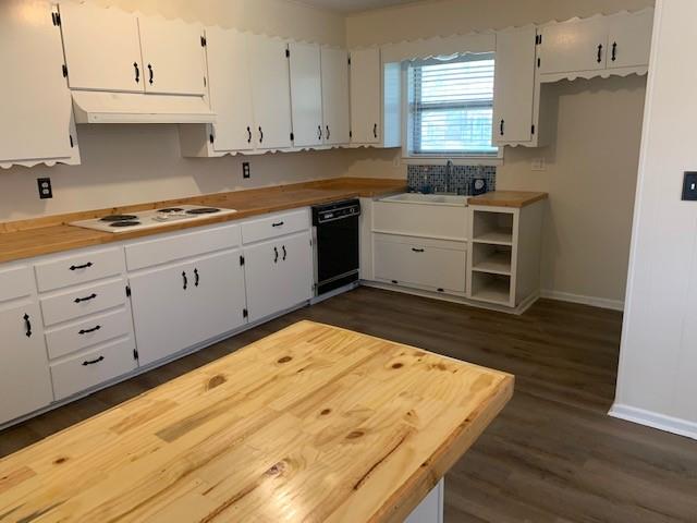 3104 South Lipsey Street Decatur, TX 76234 - Photo 8 of 18 a kitchen with granite countertop a stove a sink and white cabinets