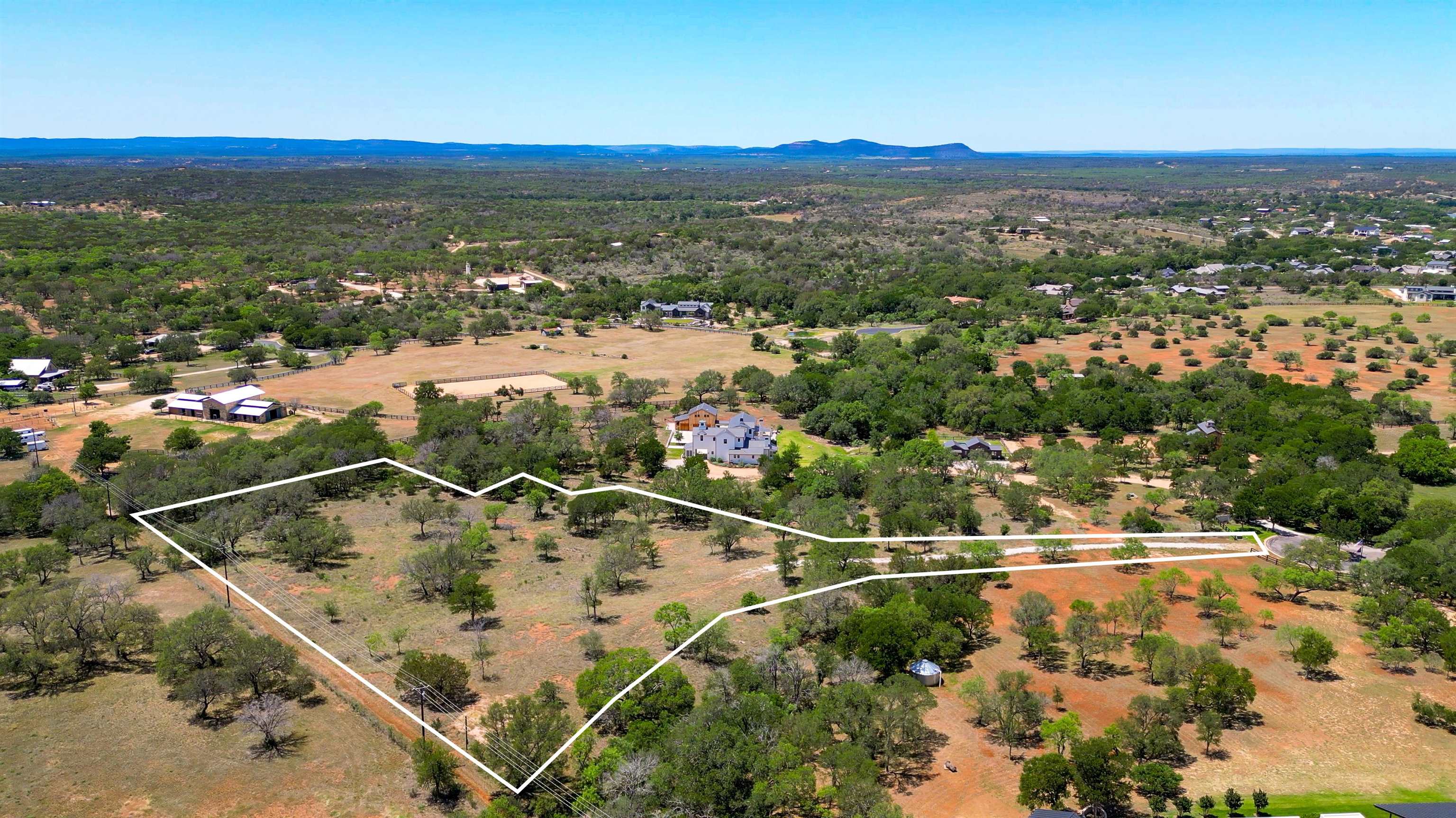 an aerial view of residential houses with outdoor space and swimming pool