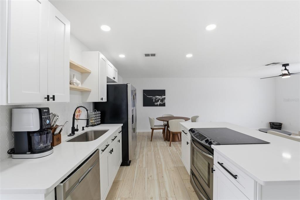 8025 San Fernando Drive Port Richey, FL 34668 - Photo 11 of 22 a kitchen with a sink stove and refrigerator