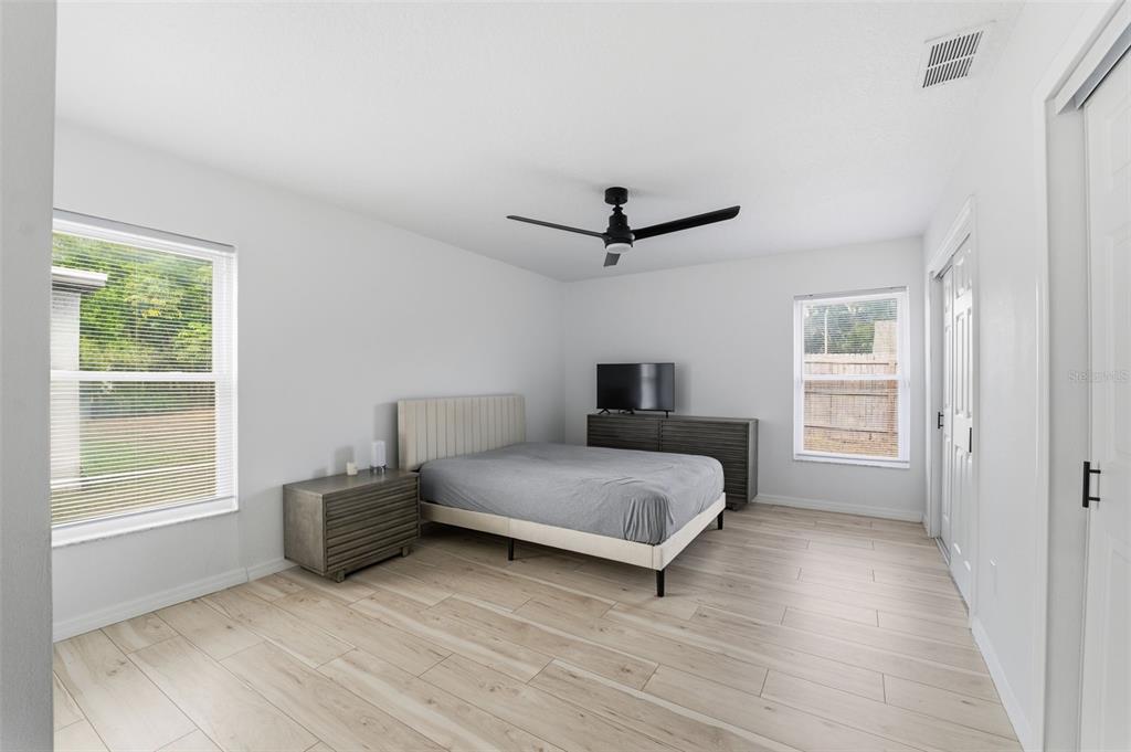 8025 San Fernando Drive Port Richey, FL 34668 - Photo 14 of 22 a spacious bedroom with a bed and a window