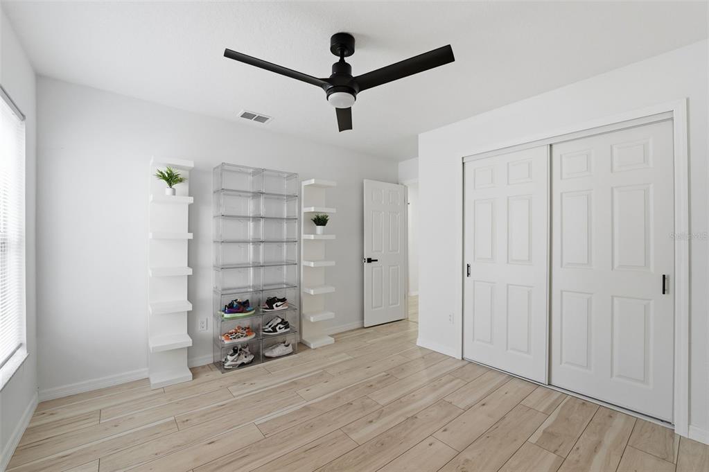 8025 San Fernando Drive Port Richey, FL 34668 - Photo 17 of 22 a view of a livingroom with wooden floor and a ceiling fan