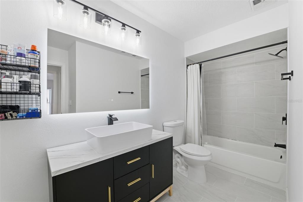 8025 San Fernando Drive Port Richey, FL 34668 - Photo 18 of 22 a bathroom with a sink a toilet and shower