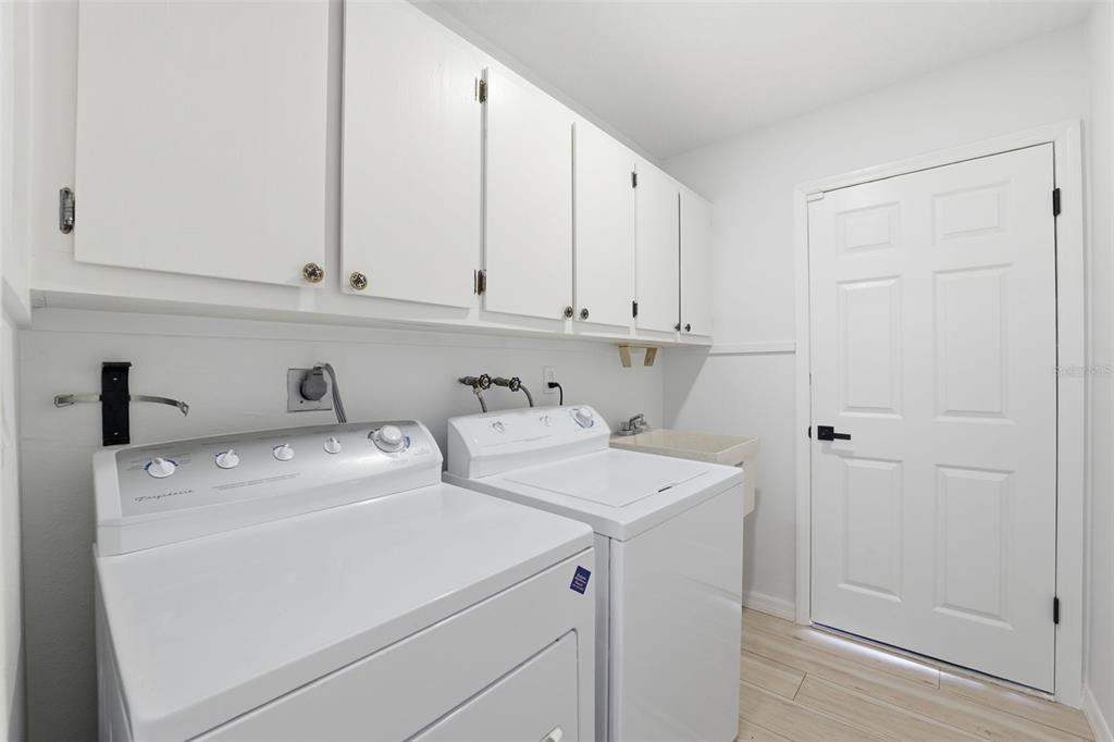8025 San Fernando Drive Port Richey, FL 34668 - Photo 20 of 22 a view of storage and utility room with washer and dryer