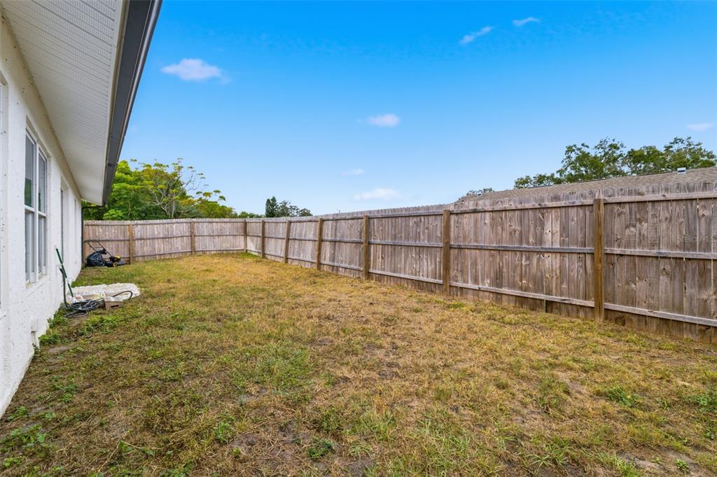 8025 San Fernando Drive Port Richey, FL 34668 - Photo 22 of 22 a view of backyard with wooden fence