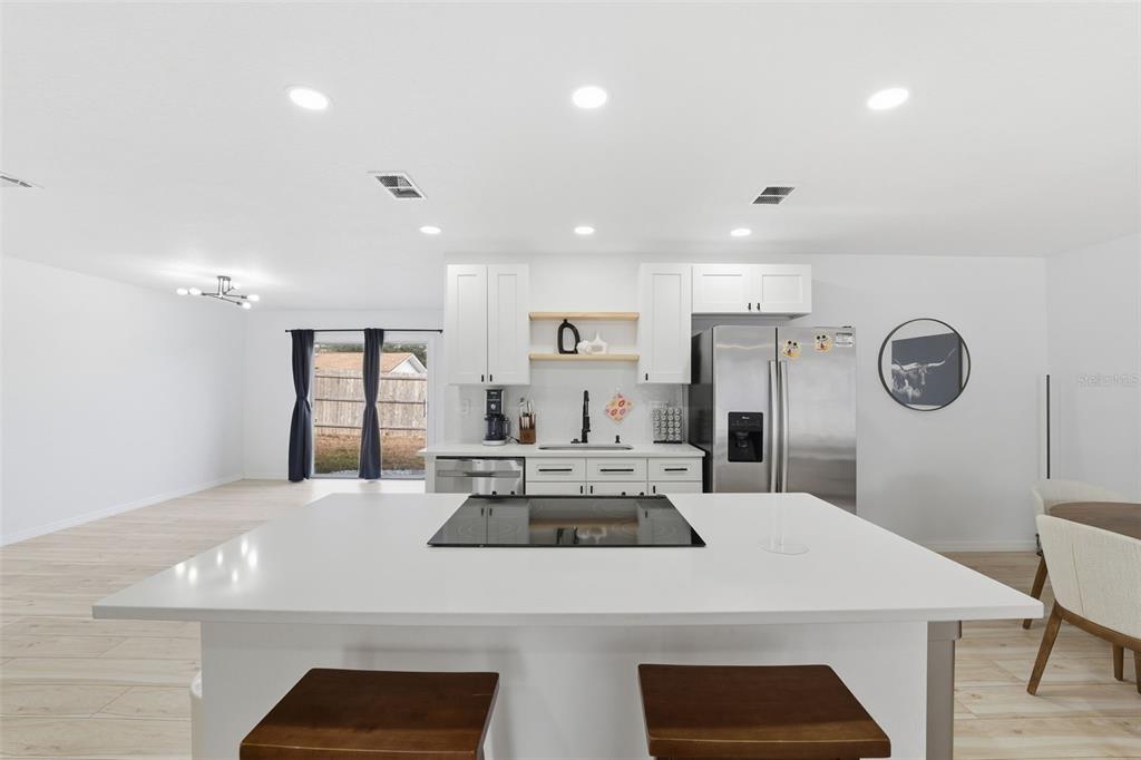 8025 San Fernando Drive Port Richey, FL 34668 - Photo 8 of 22 a large kitchen with a table and chairs