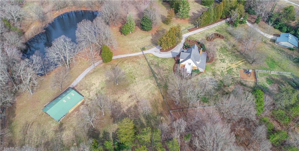 5606 Wallburg-High Point Road High Point, NC 27265 - Photo 2 of 30 Alternative view of this IMPRESSIVE property...every corner of this acreage offers another prestigious feature. In addition to the multiple buildings, this estate includes a fenced garden with raised beds, a firepit area, and a playground. *Note, there is well water available for outdoor usage.