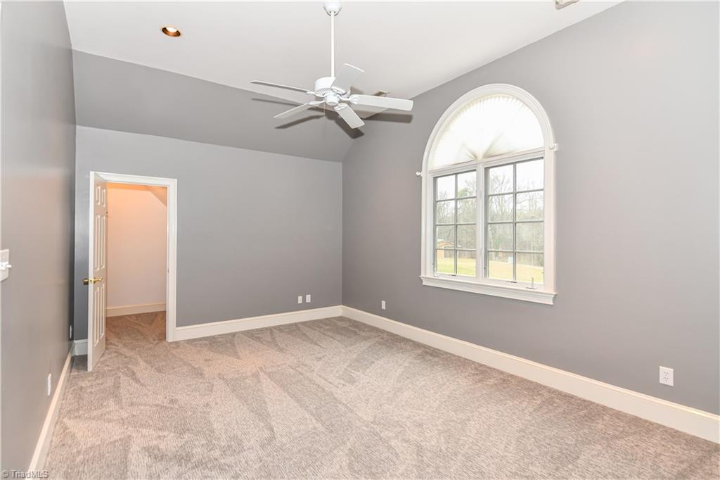 5606 Wallburg-High Point Road High Point, NC 27265 - Photo 14 of 30 The second bedroom has carpet flooring, vaulted ceiling, recessed lighting, ceiling fan, and a walk-in closet.