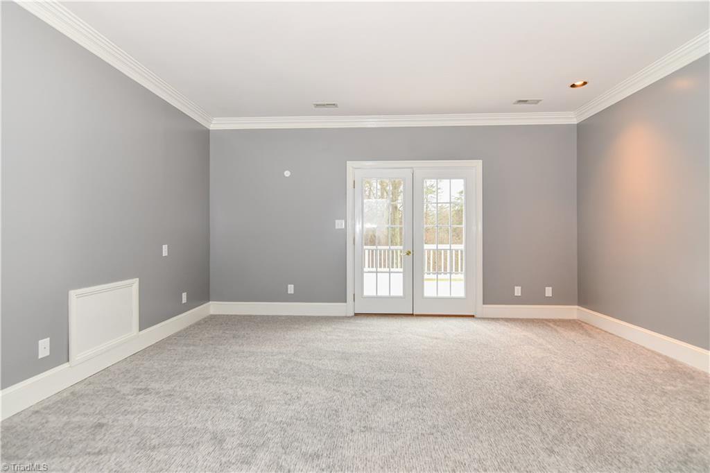 5606 Wallburg-High Point Road High Point, NC 27265 - Photo 16 of 30 The master bedroom has carpet flooring, recessed lighting, and double French doors that lead onto private deck.