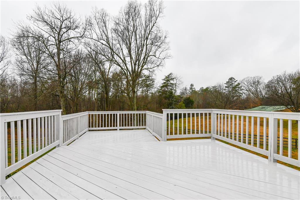 5606 Wallburg-High Point Road High Point, NC 27265 - Photo 17 of 30 Step out from the master suite onto the owner's deck...bird watching and views of the pasture + pond are plentiful! (*Note, fresh stain applied 2020)