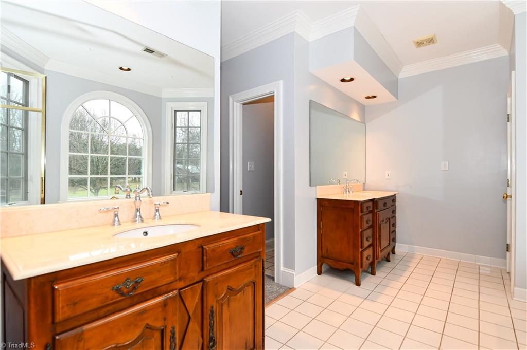5606 Wallburg-High Point Road High Point, NC 27265 - Photo 18 of 30 The master bathroom has tile flooring, furniture style vanities, water closet, and linen closet.