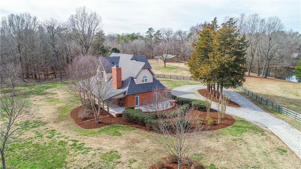 5606 Wallburg-High Point Road High Point, NC 27265 - Photo 3 of 30 As you are enter through the double gated entry, you are greeted with professional landscaping and night lighting. The front entrance also has a gravel circle driveway.
