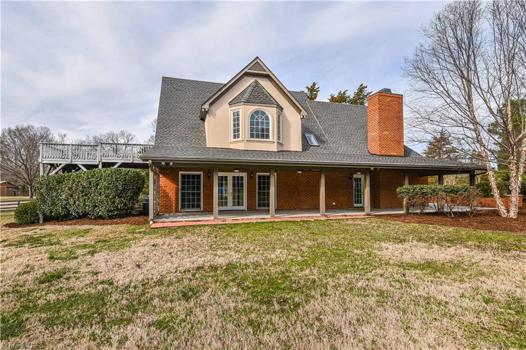 5606 Wallburg-High Point Road High Point, NC 27265 - Photo 23 of 30 The back elevation offers a view of the second level master suite bay window and deck, as well as the main level covered entertaining area.