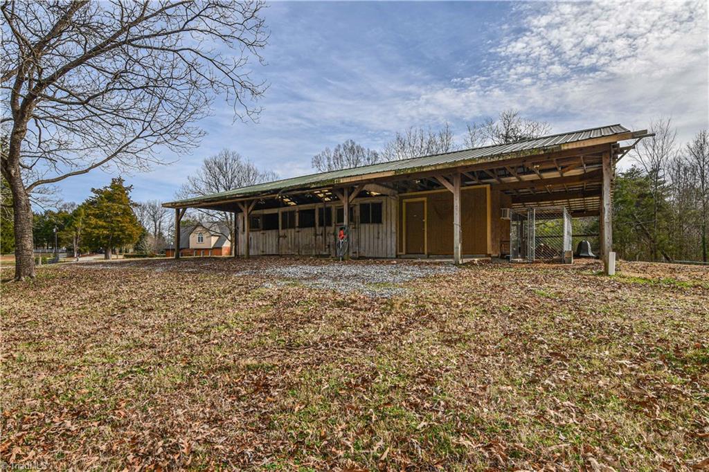 5606 Wallburg-High Point Road High Point, NC 27265 - Photo 29 of 30 The three stall pole barn also includes a tack room with utility sink, kennel area, and a HUGE workshop/storage room on the opposite side.