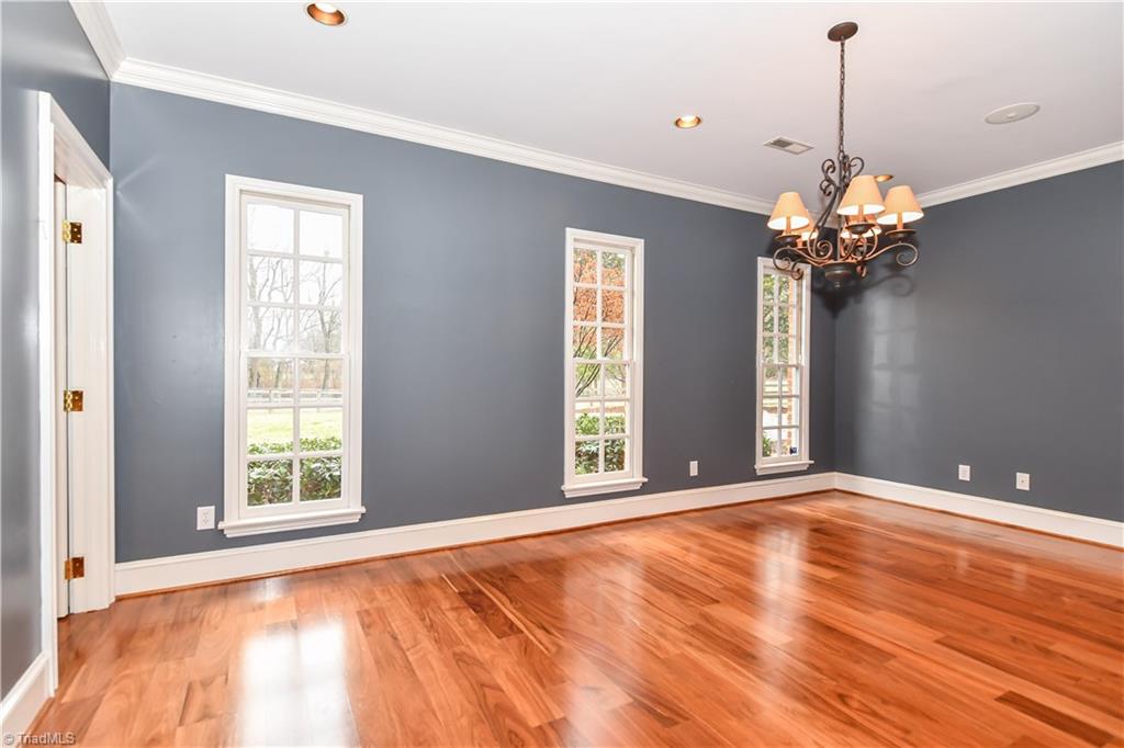 5606 Wallburg-High Point Road High Point, NC 27265 - Photo 8 of 30 The elegant formal dining room has three windows for natural sunlight, hardwood flooring, recessed lighting, and surround sound speakers.