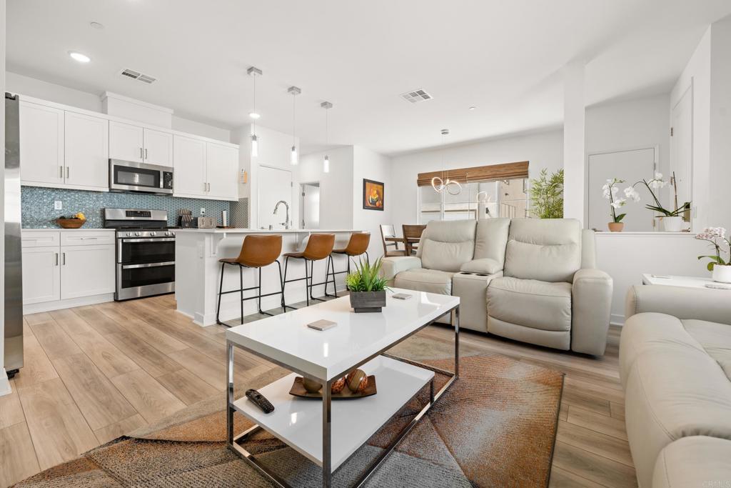 35115 Crop Place Fallbrook, CA 92028 - Photo 1 of 41 a living room with furniture a kitchen view and a appliances